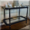 F23. Tiered painted tea cart with glass shelves. 32”h x 42”w x 20”d 